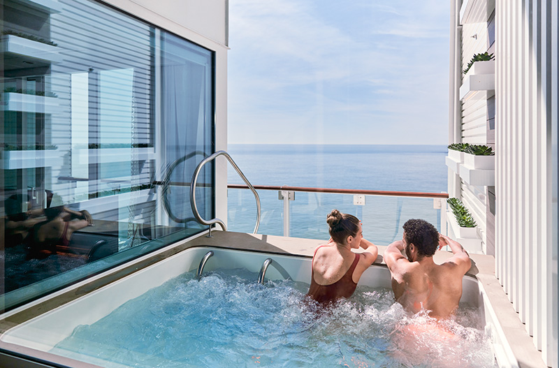 Couple enjoying a private spa with an ocean view
